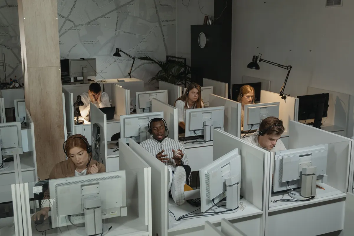 Call centre agents working at their desks with headsets