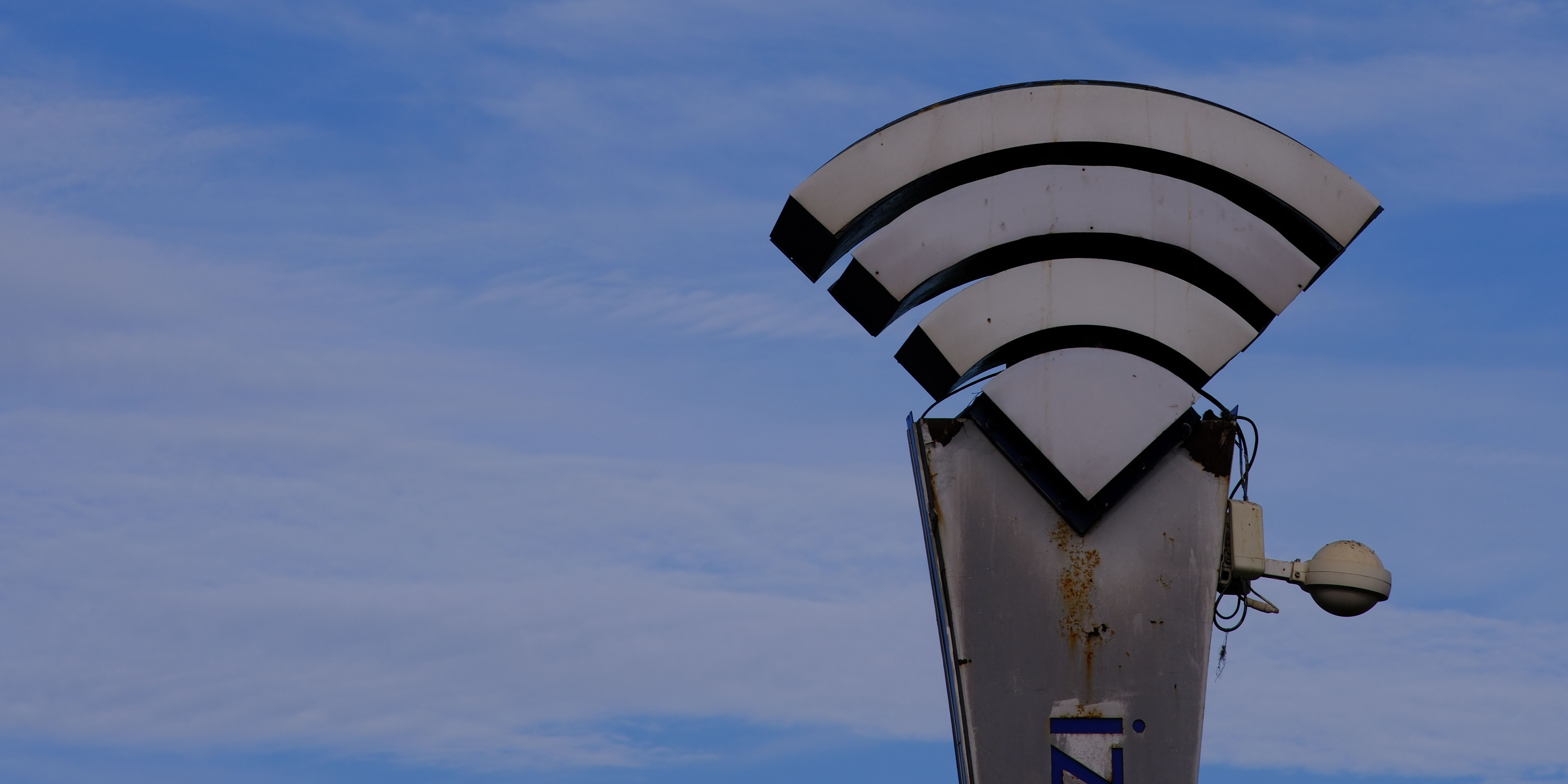 Wi-Fi sign against a blue sky