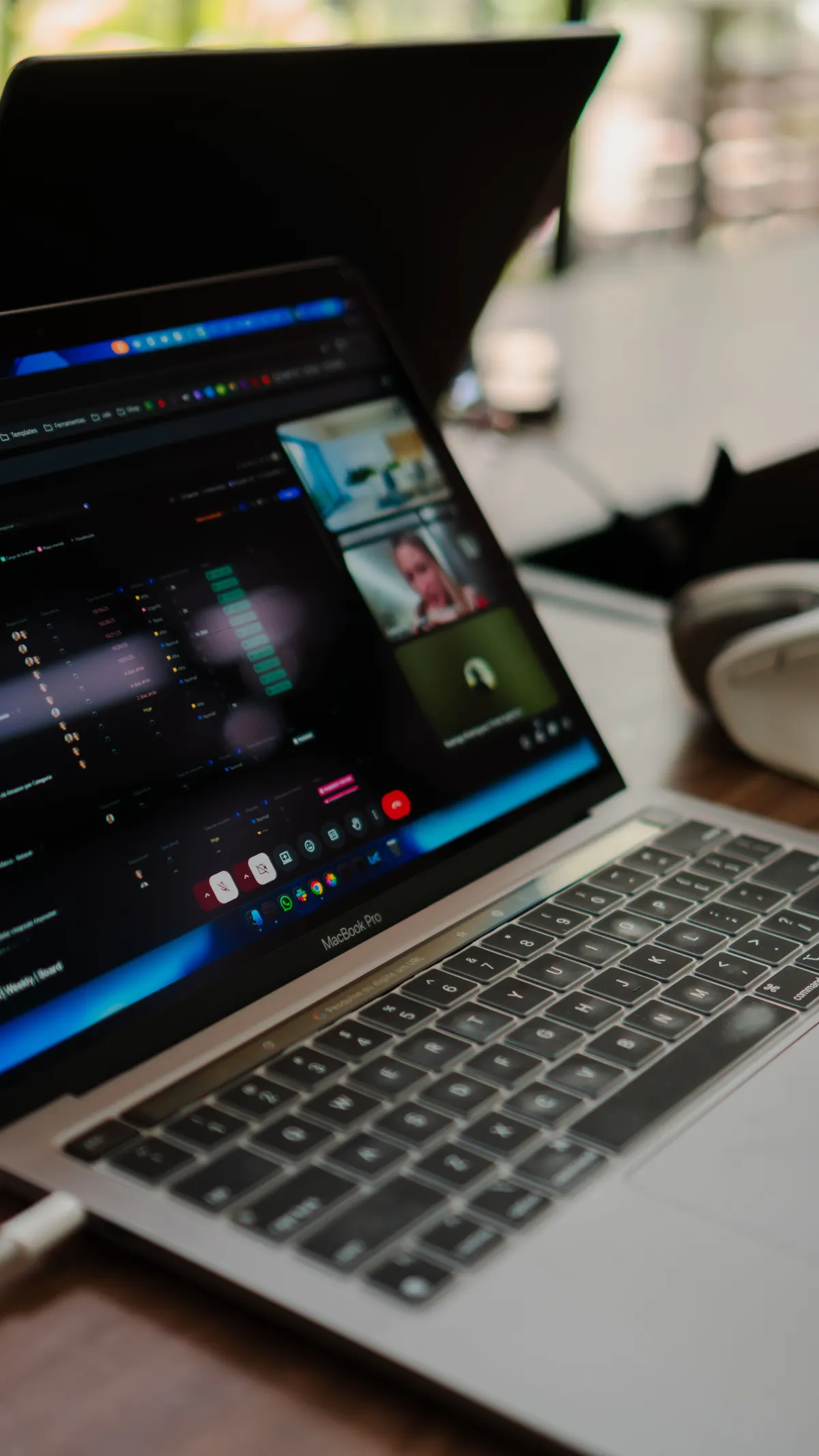 Laptop screen showing a call analytics dashboard and video call
